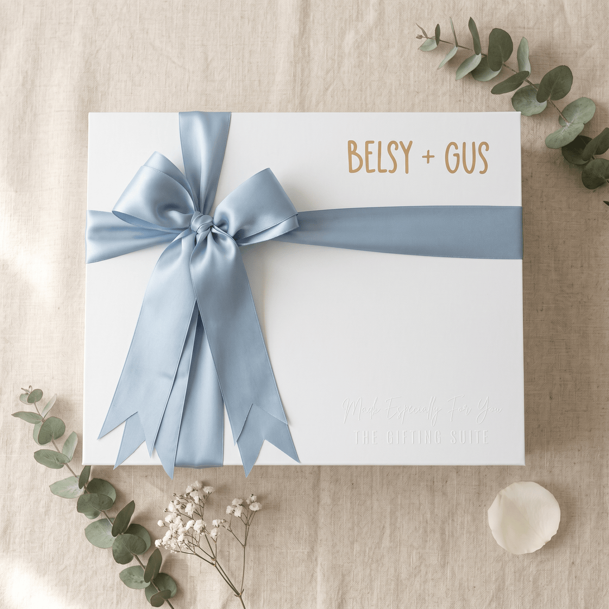 White personalised gift box with blue ribbon and name