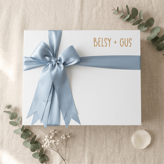 White personalised gift box with blue ribbon and name